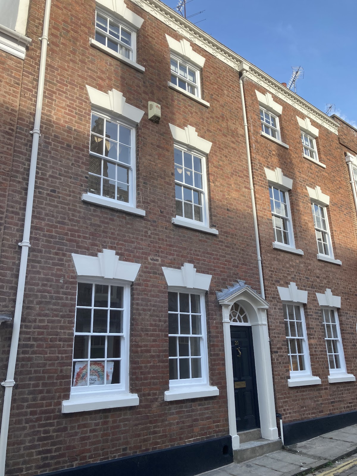 Georgian townhouse with freshly painted white window surrounds and black front door