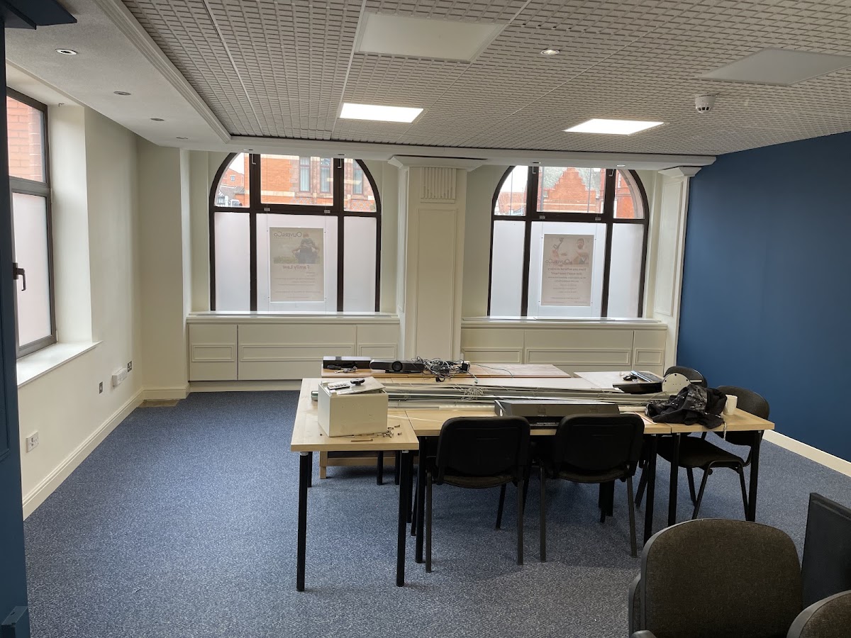 Commercial office decorated in cream with a navy feature wall and arched windows