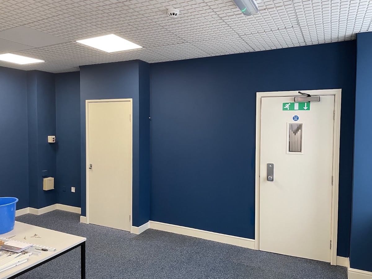 Commercial interior with deep navy feature walls and cream doors and trim